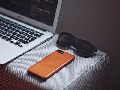 photo of keyboard, cell phone, and sunglasses